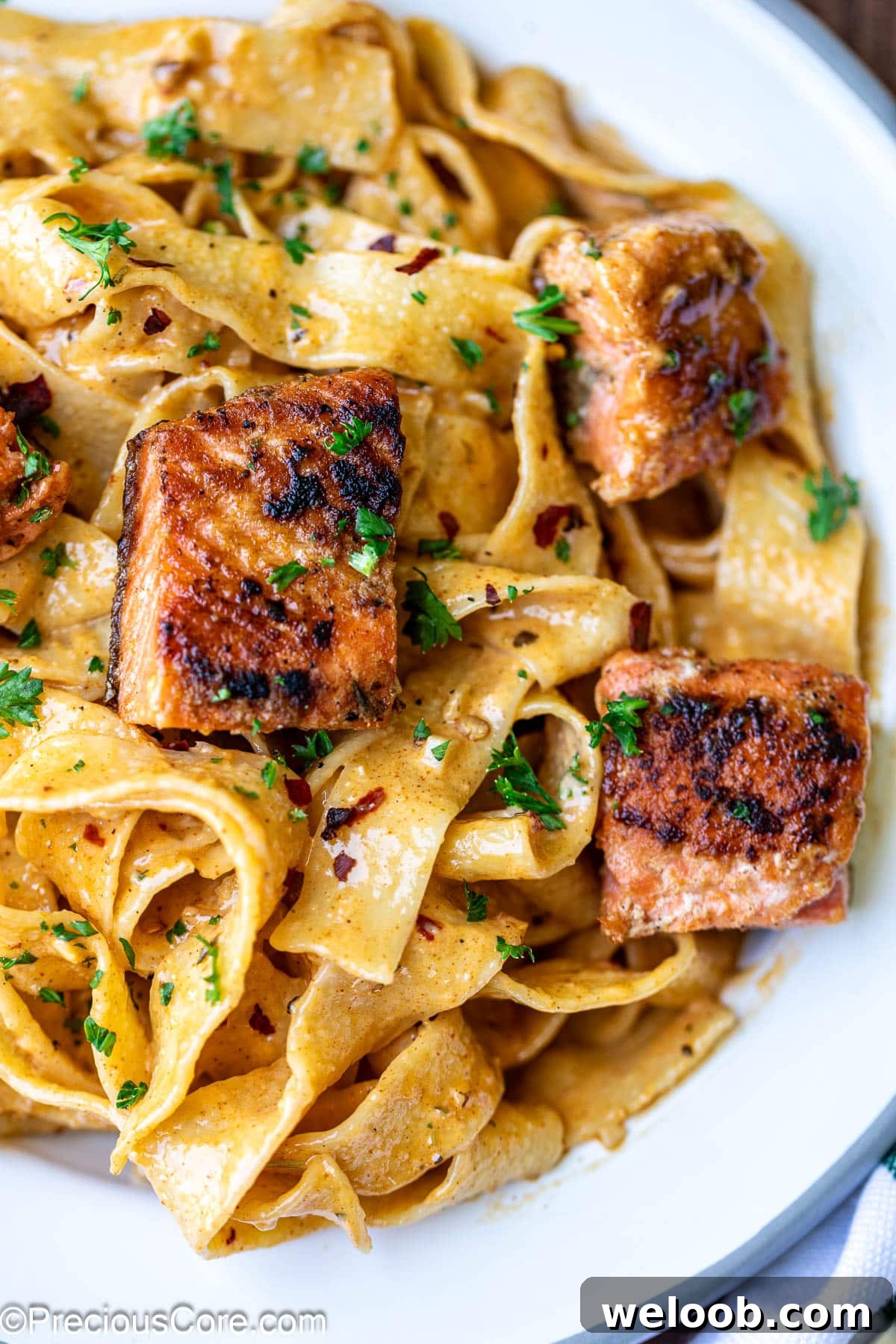Cajun Pasta with Salmon with fresh parsley.