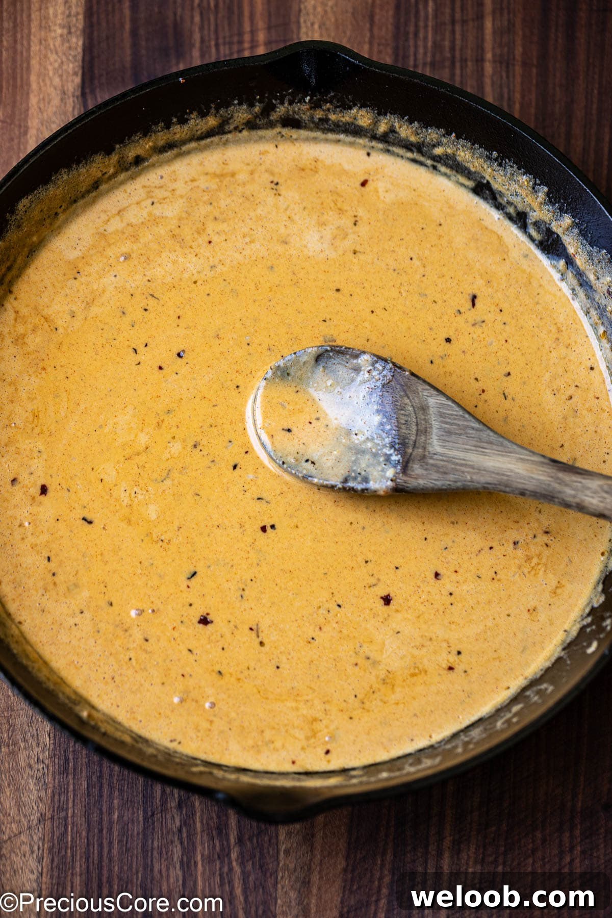 Stirring homemade creamy cajun pasta sauce.