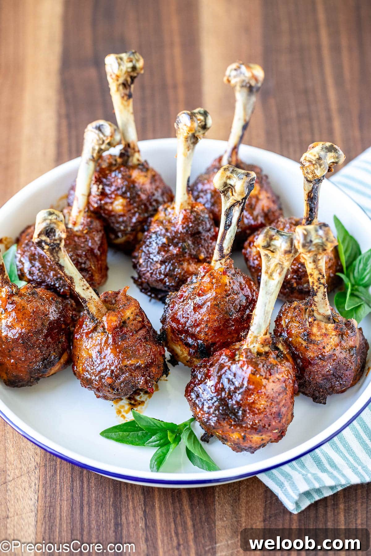 Plate of baked and glazed chicken lollipops.