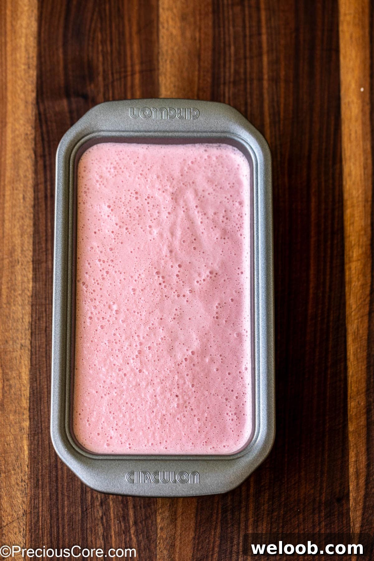 Watermelon ice cream mixture in a loaf pan.