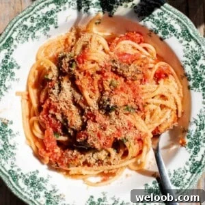 A close up of tomato sardine pasta topped with breadcrumbs.