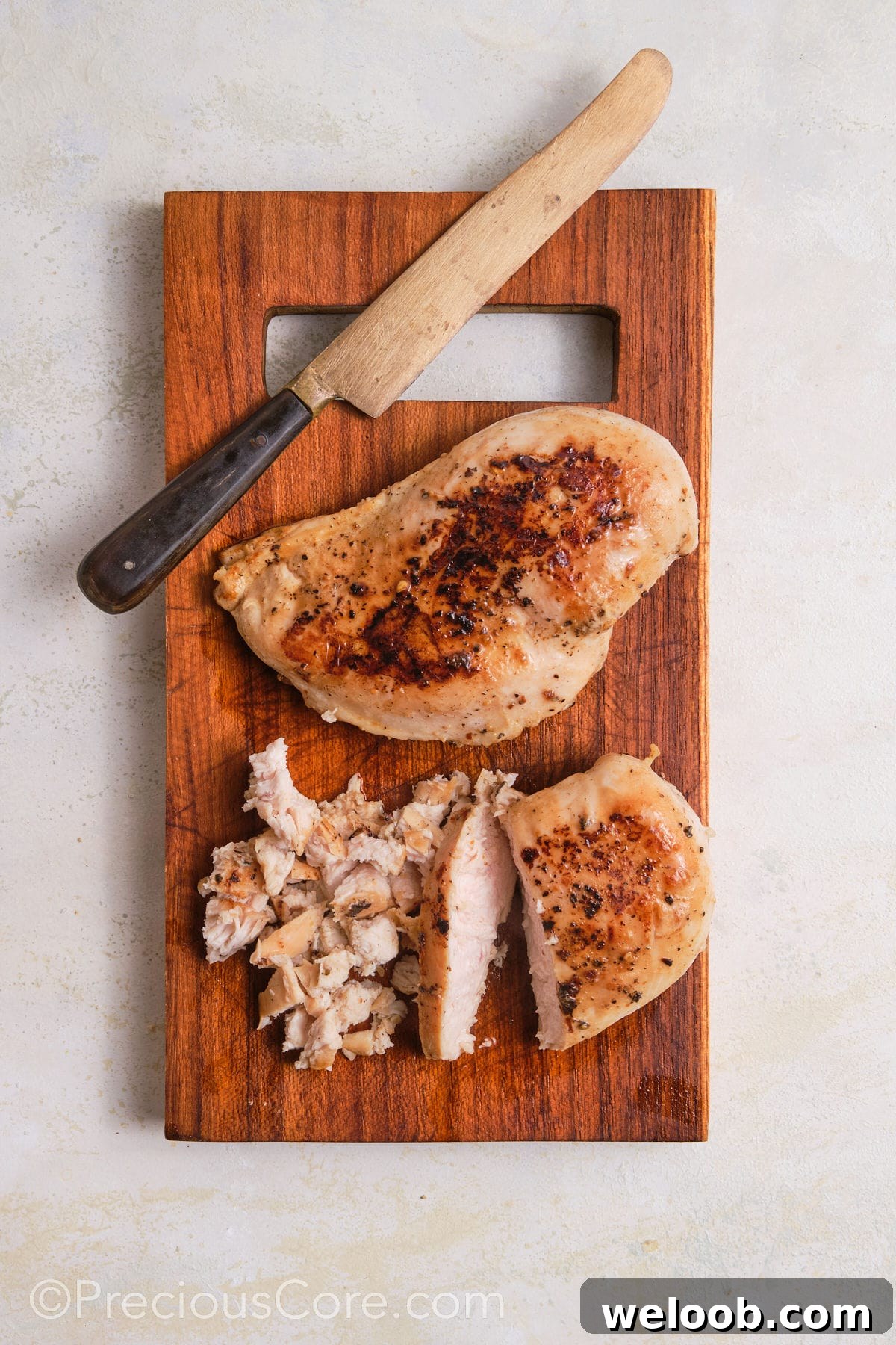 Dicing chicken breasts into small pieces.