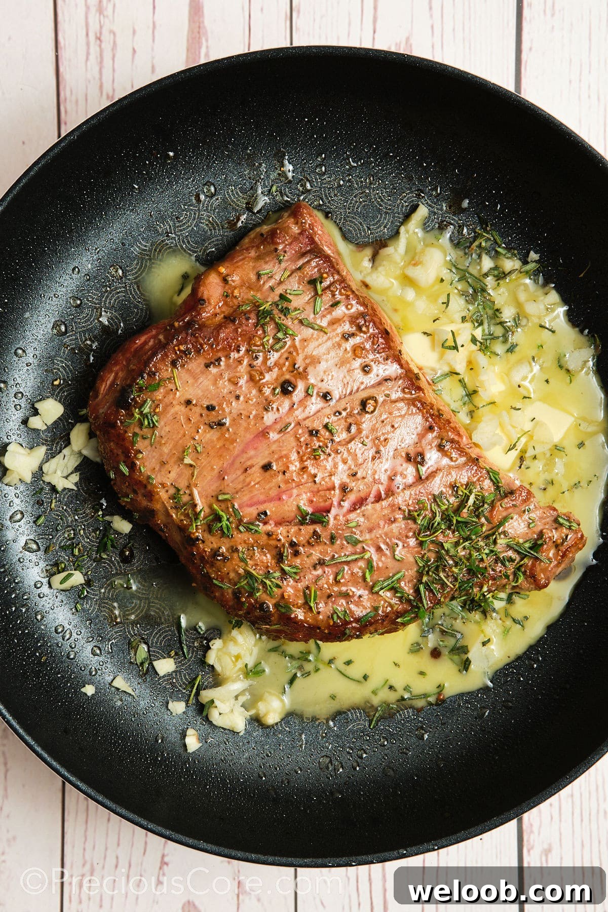 Butter added to pan with steak.
