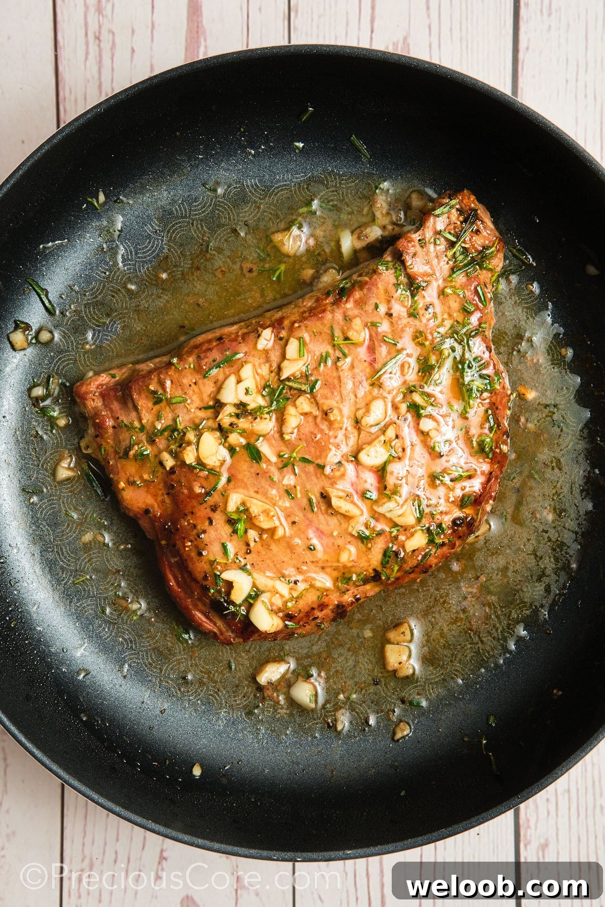 Pan seared flank steak with garlic herb butter sauce.