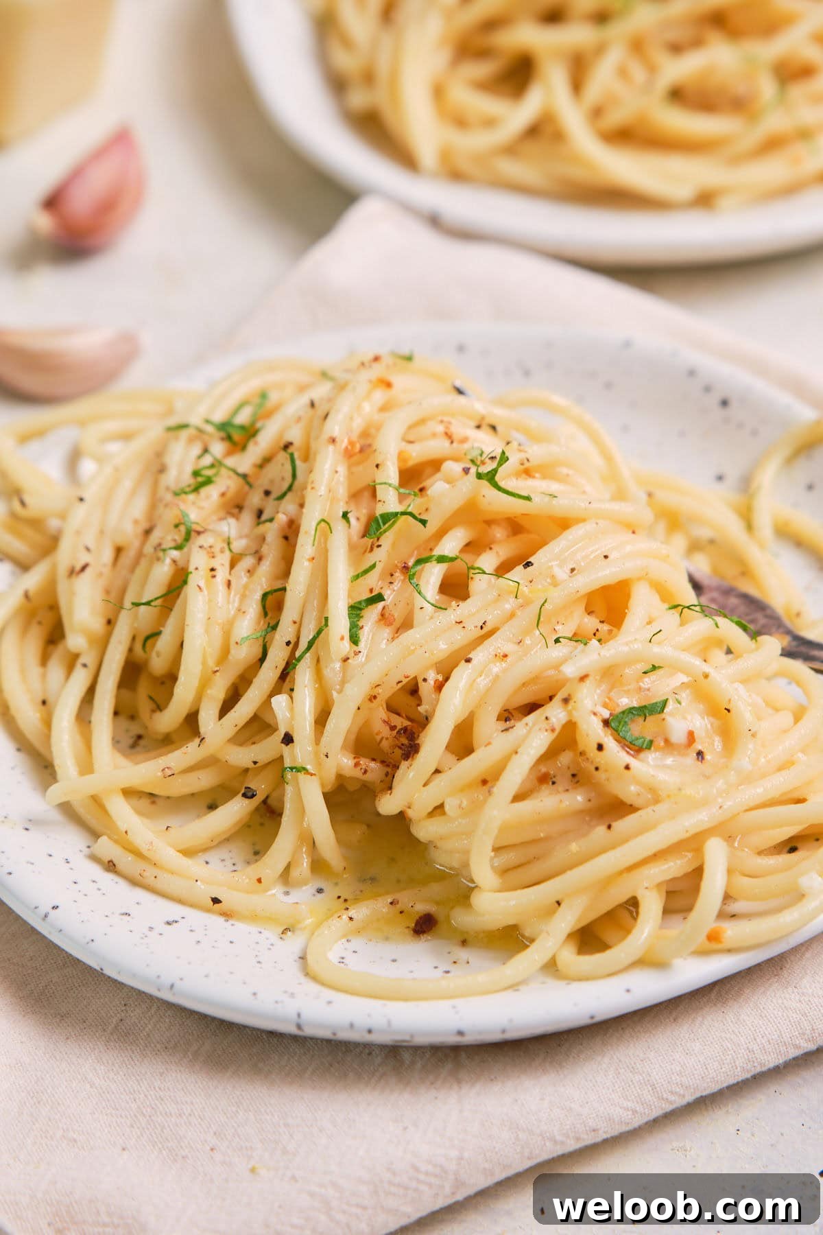 Lemon Garlic Butter Pasta on a speckled plate.