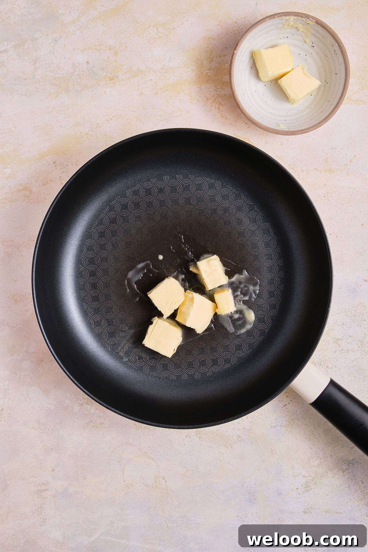 Butter melting in skillet.