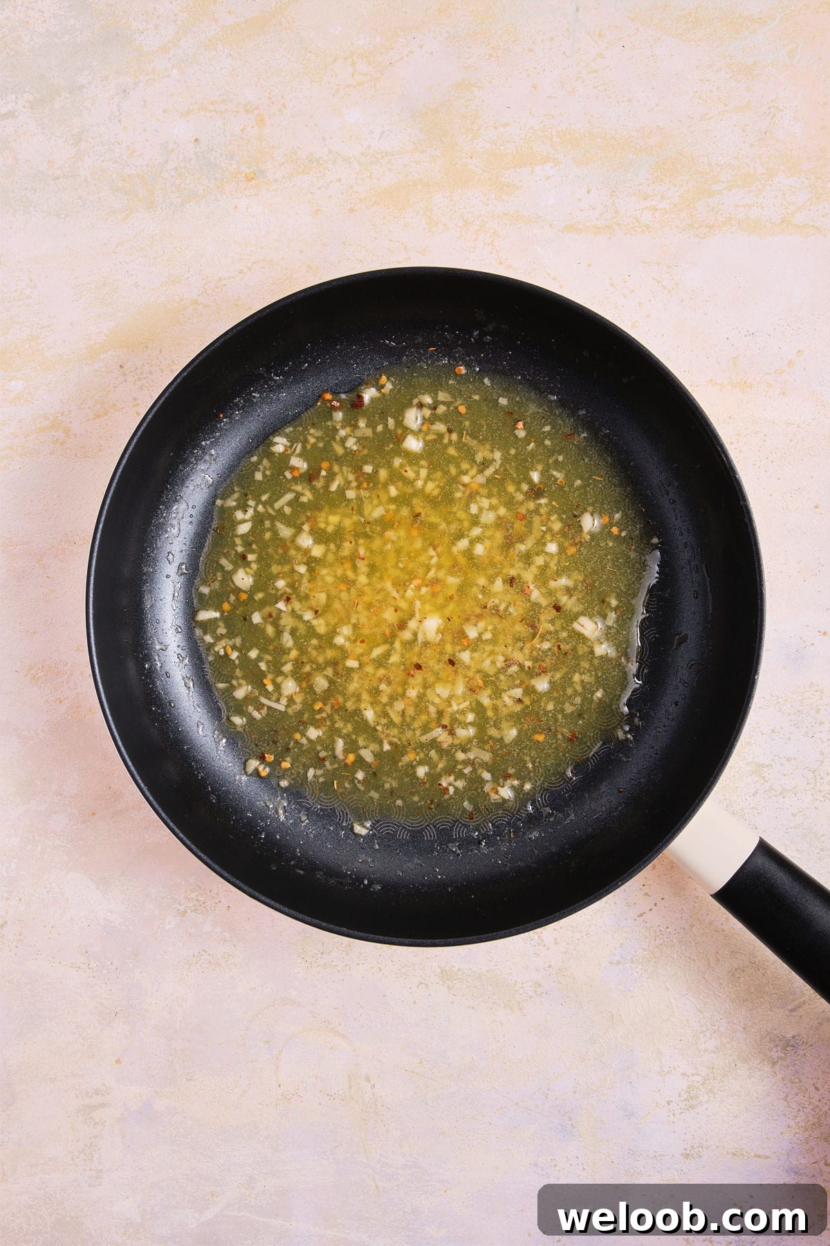 Cooked garlic butter sauce in skillet.