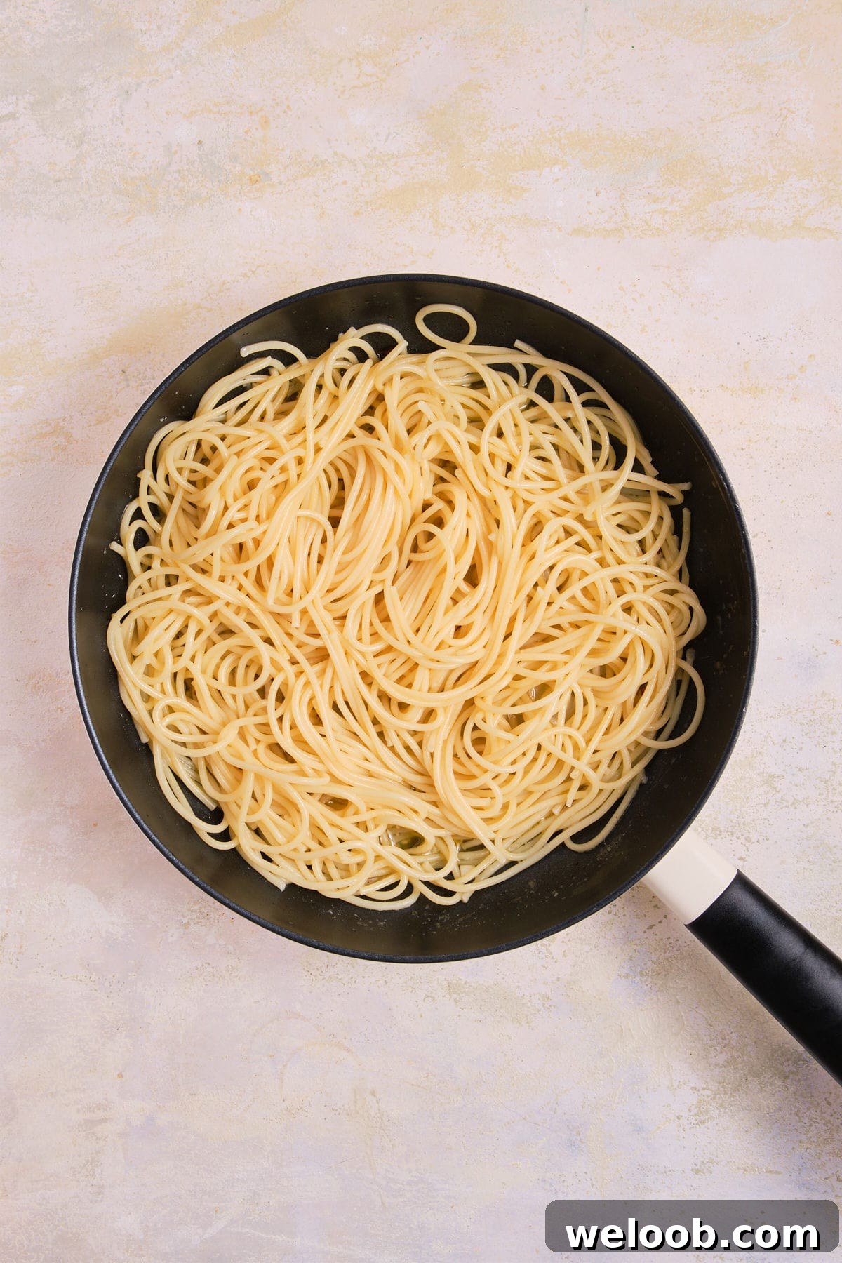 Pasta added to skillet.