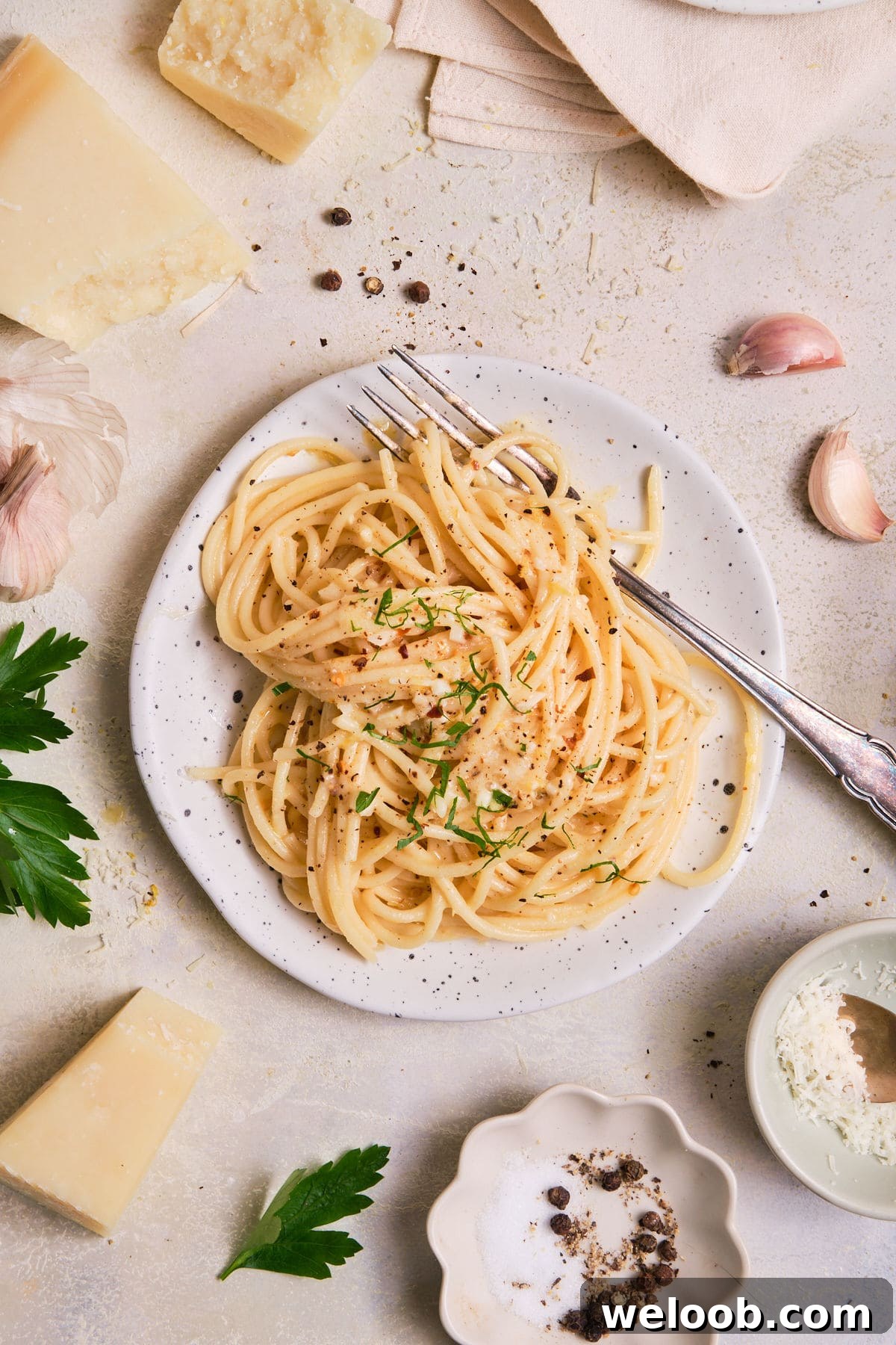 Pasta on a plate with ingredients nearby.