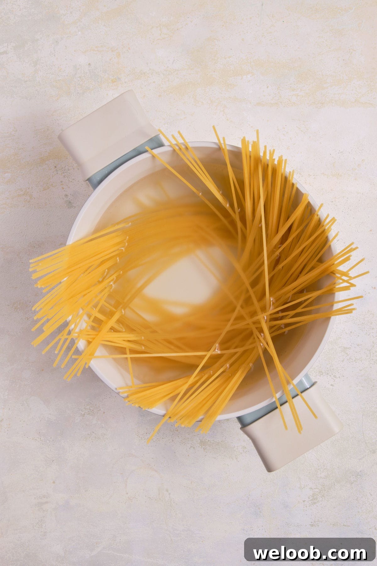 Spaghetti in a pot of water.