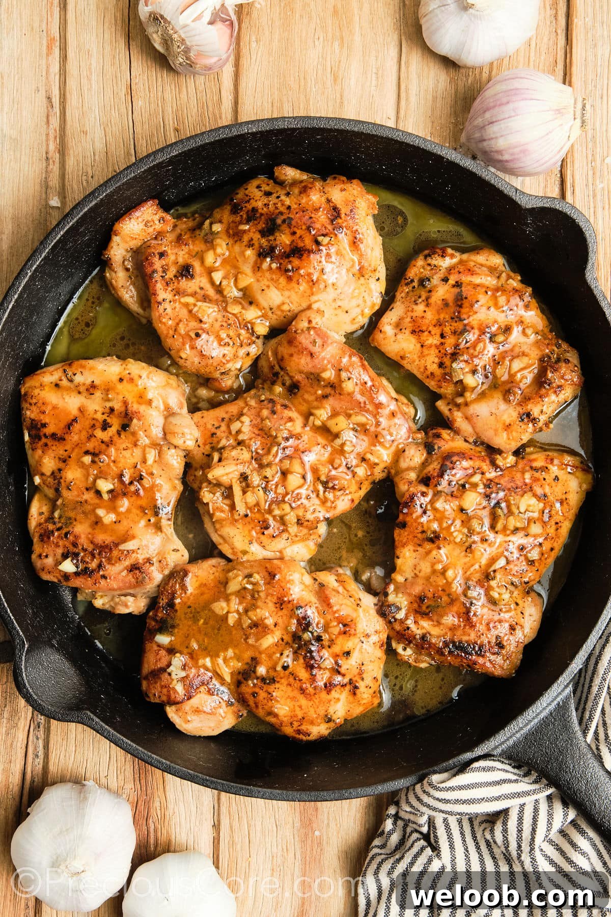 Cooked chicken thighs in a cast iron skillet.