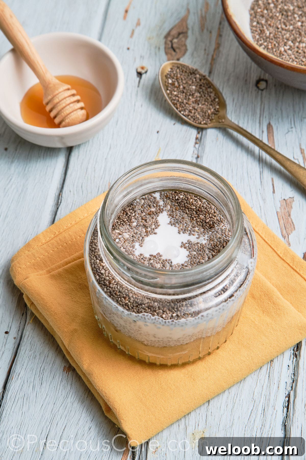 Chia pudding mixture in glass jar.