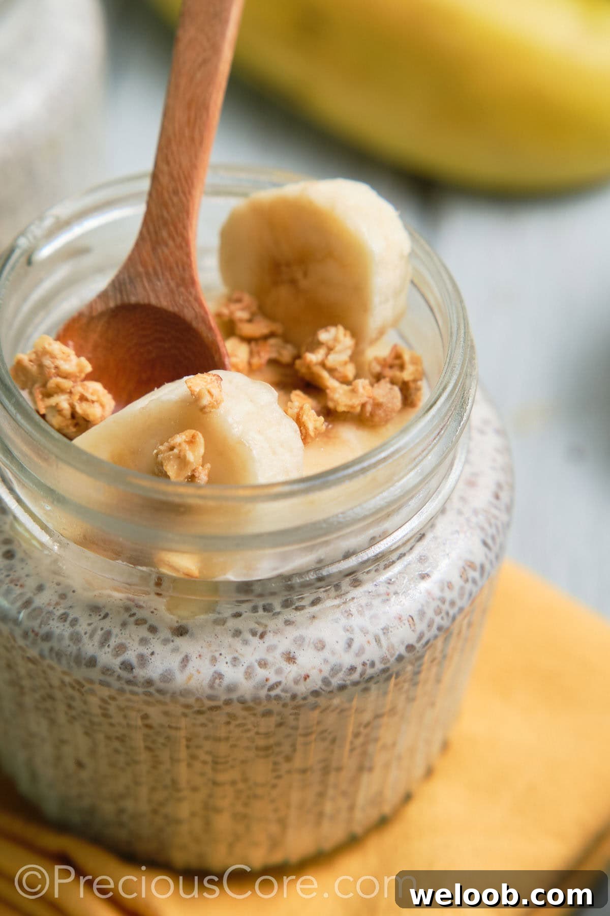 Spoon in a jar of banana chia pudding.