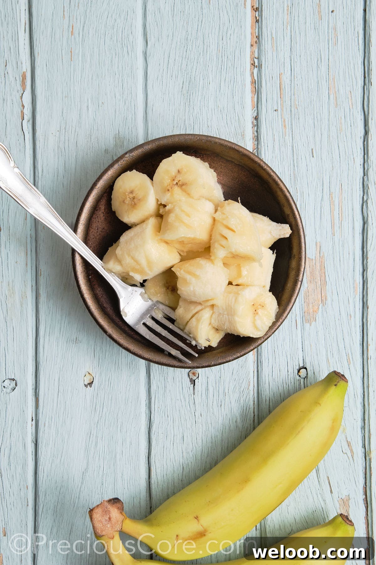 Mashing bananas in a bowl.