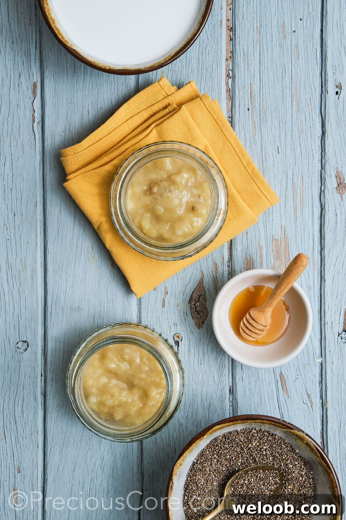 Adding mashed bananas to glass jars.