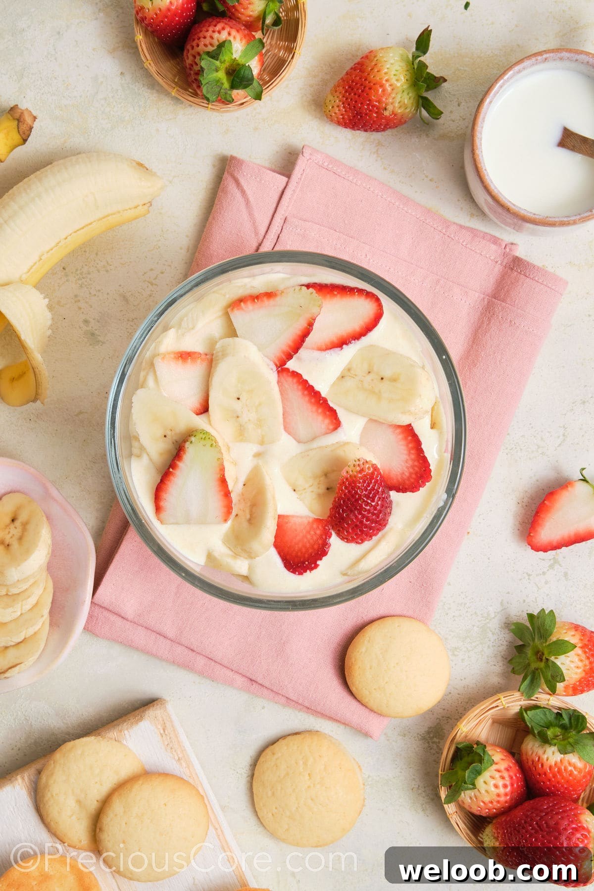 A layer of strawberries and bananas over pudding.