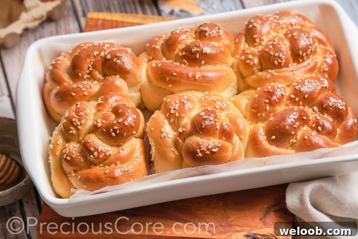 Landscape image of challah dinner rolls.