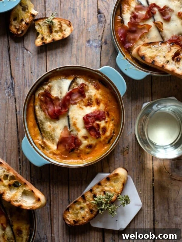 Eggplant lasagna in blue dishes with grilled ciabatta
