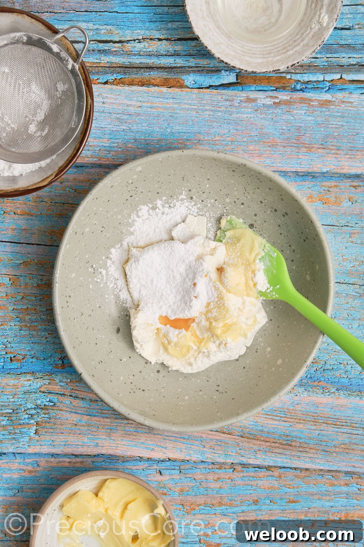 Ingredients for cream cheese frosting in a bowl.