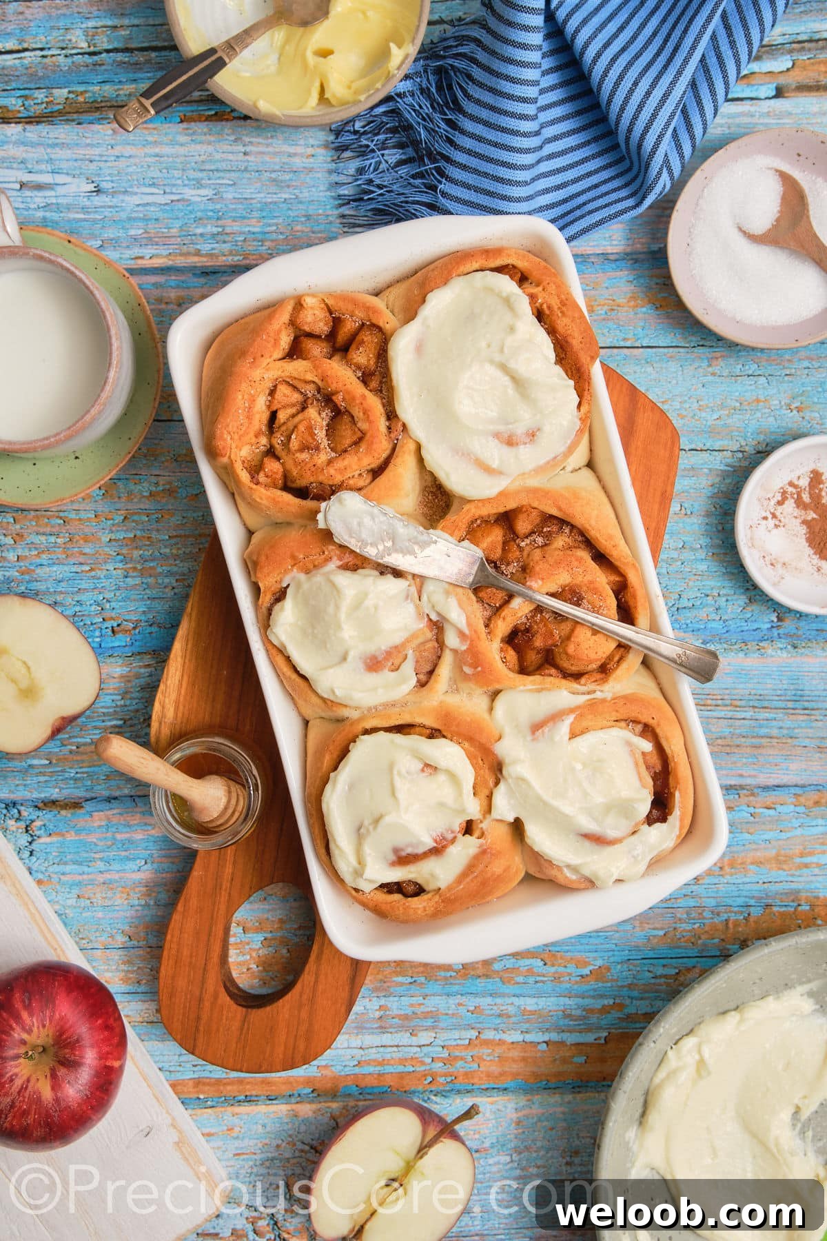 Wide shot of cinnamon rolls with apple pie filling.