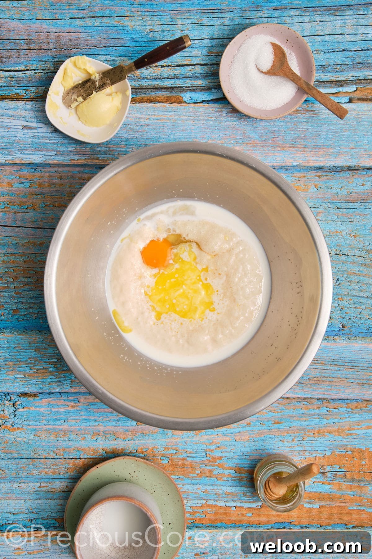 Egg and melted butter added to milk.