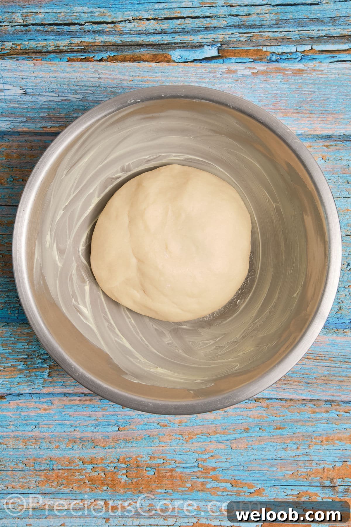 Dough in a buttered bowl.