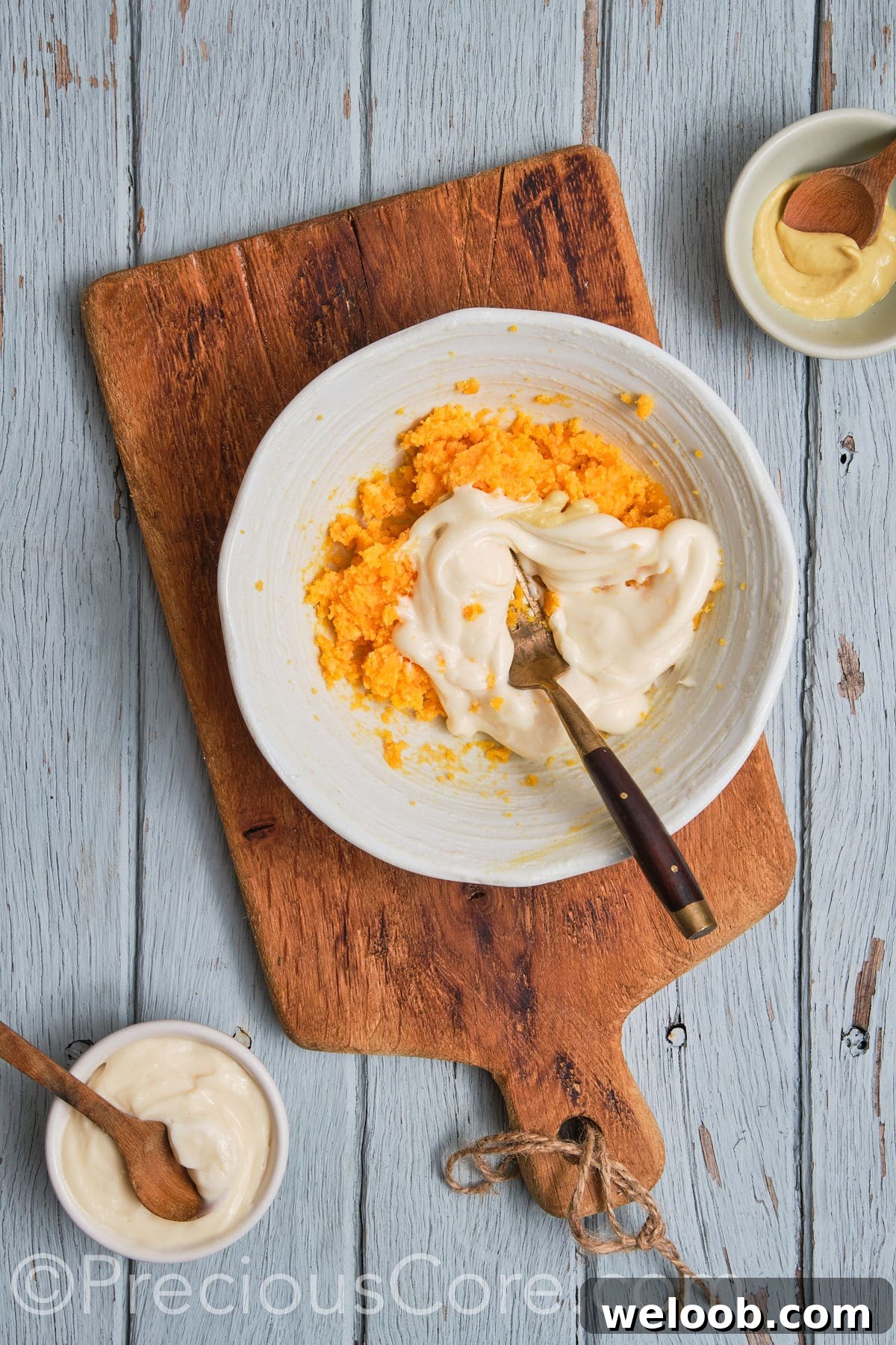 Mashed egg yolks with remaining ingredients.