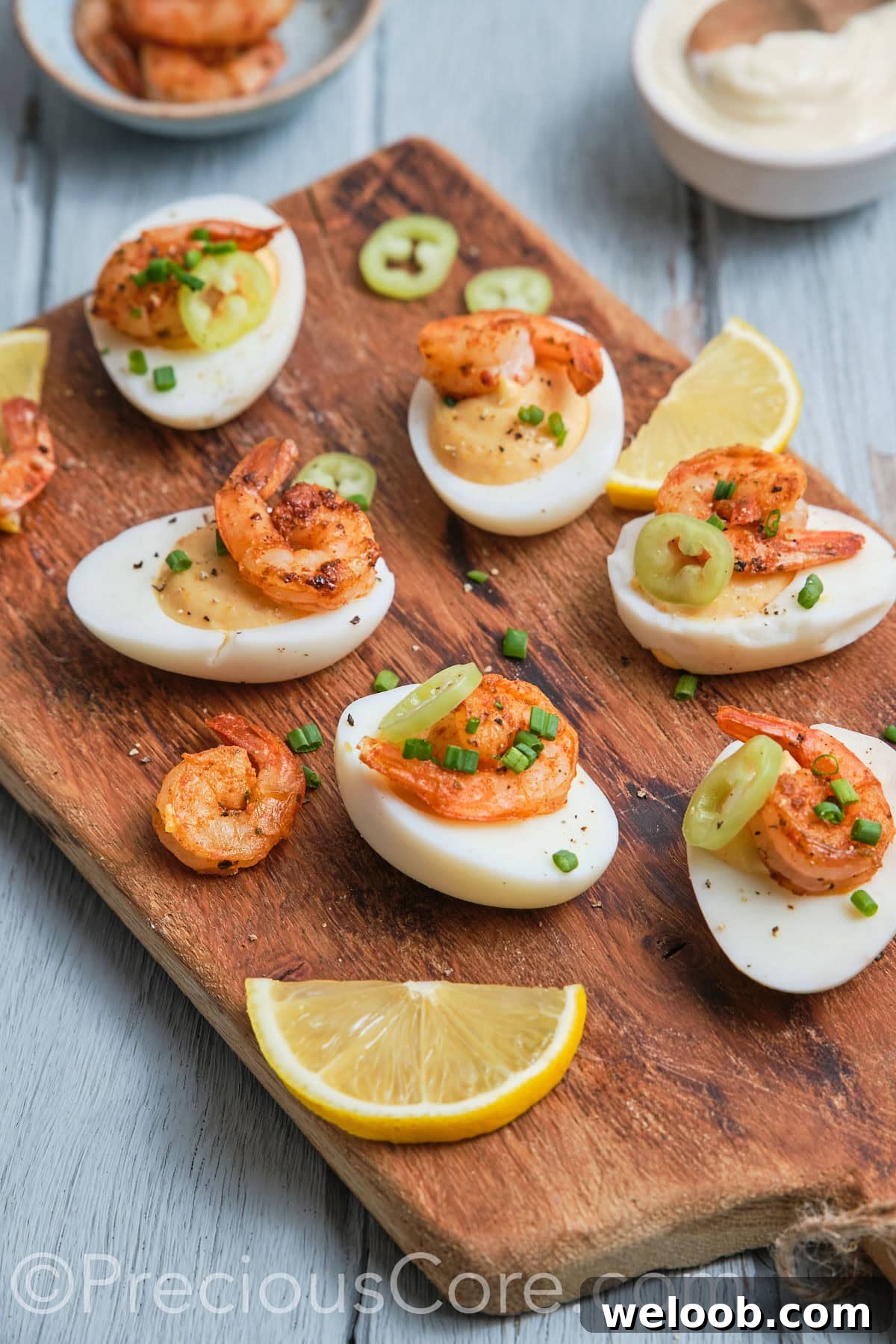 Side shot of delicious-looking deviled eggs topped with shrimp.