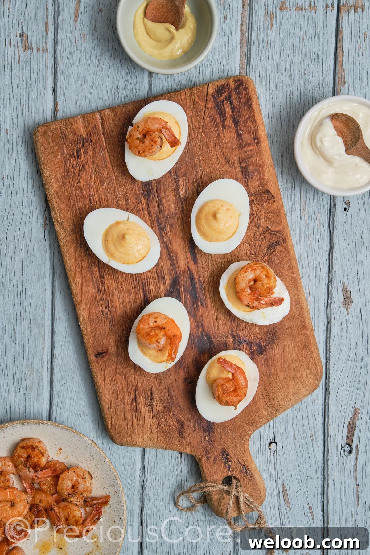 devilled eggs topped with shrimp.