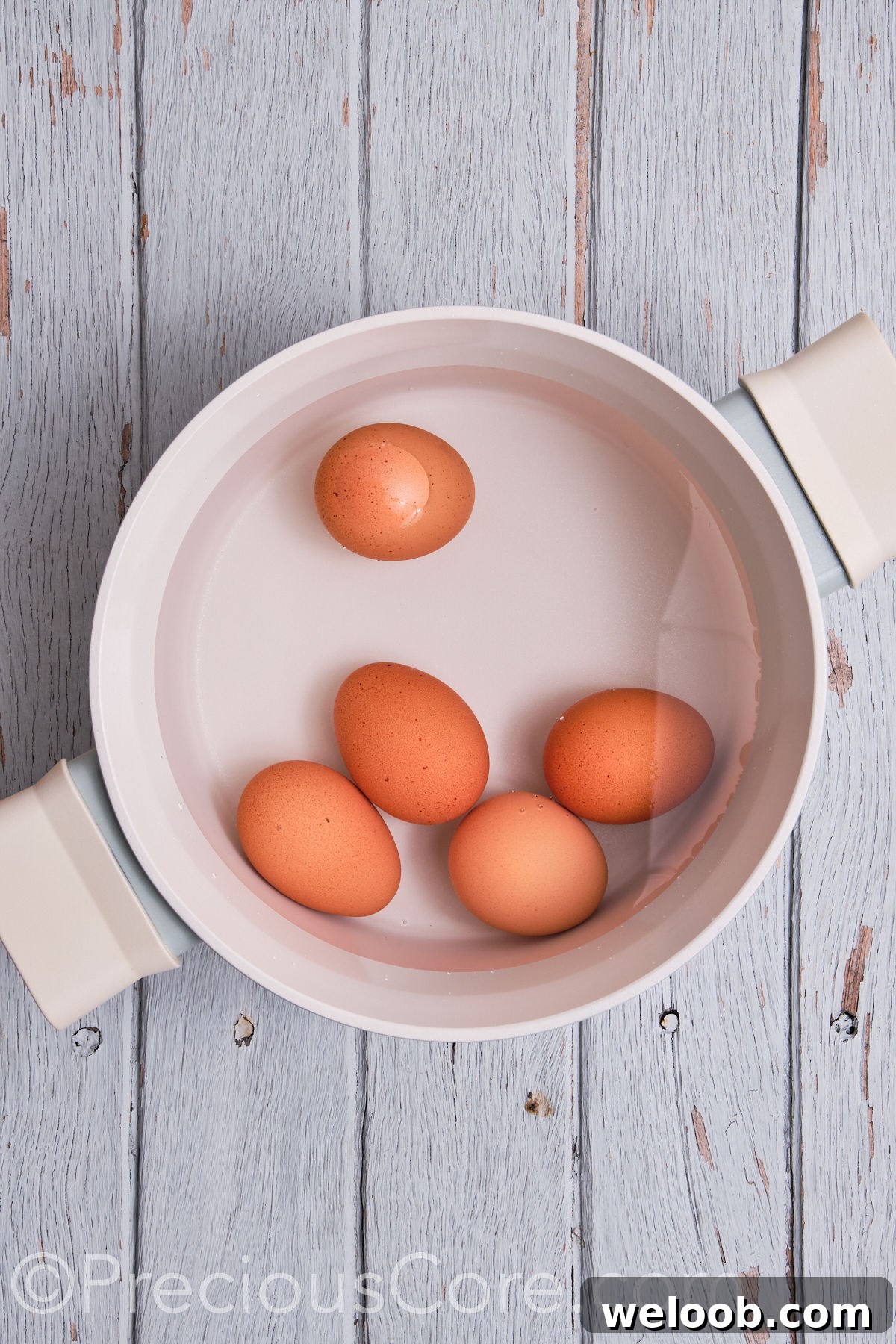 Eggs in a pot of water.
