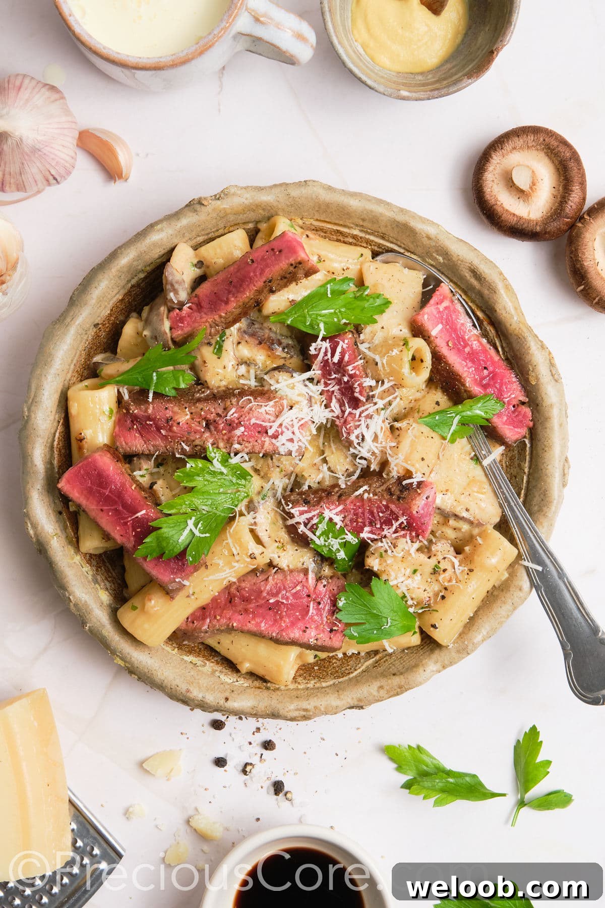 Pasta served topped with steak.