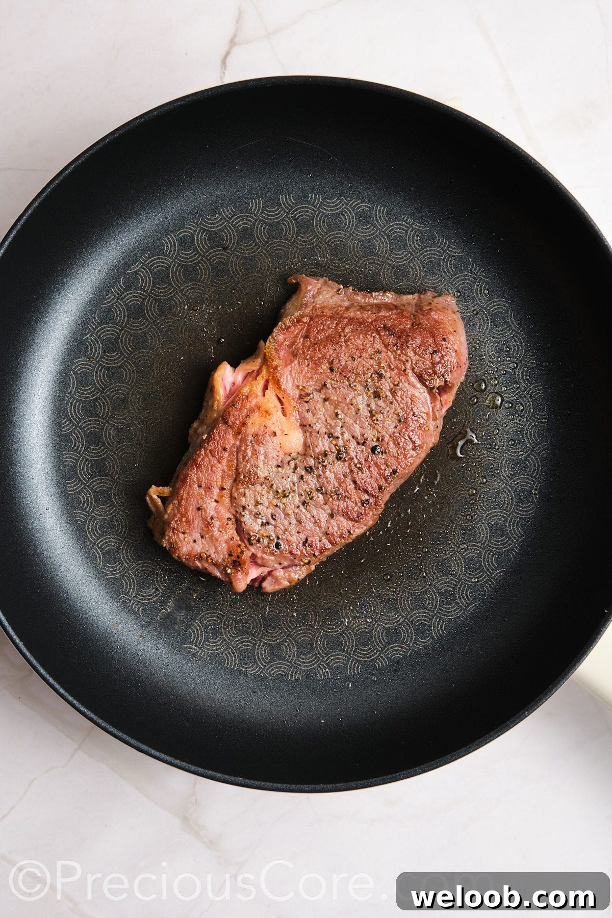 Steak cooked in a skillet.