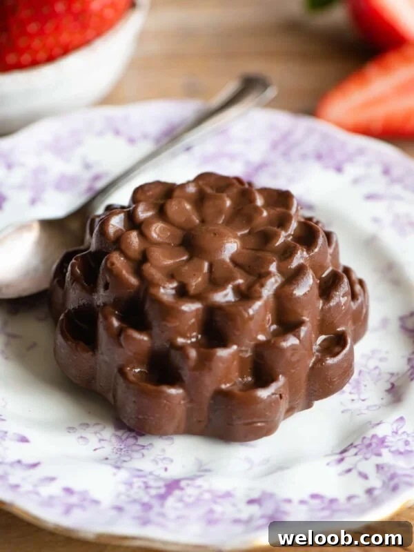 Chocolate Budino shaped like a flower on a small pink patterned plate
