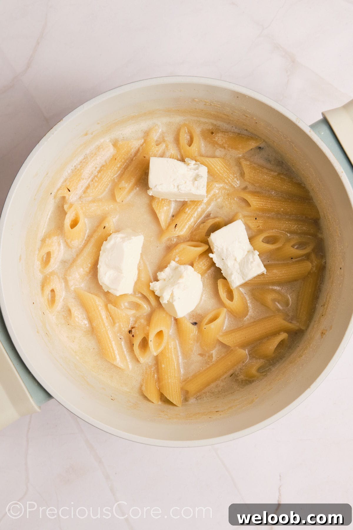 Cream cheese added to pasta.