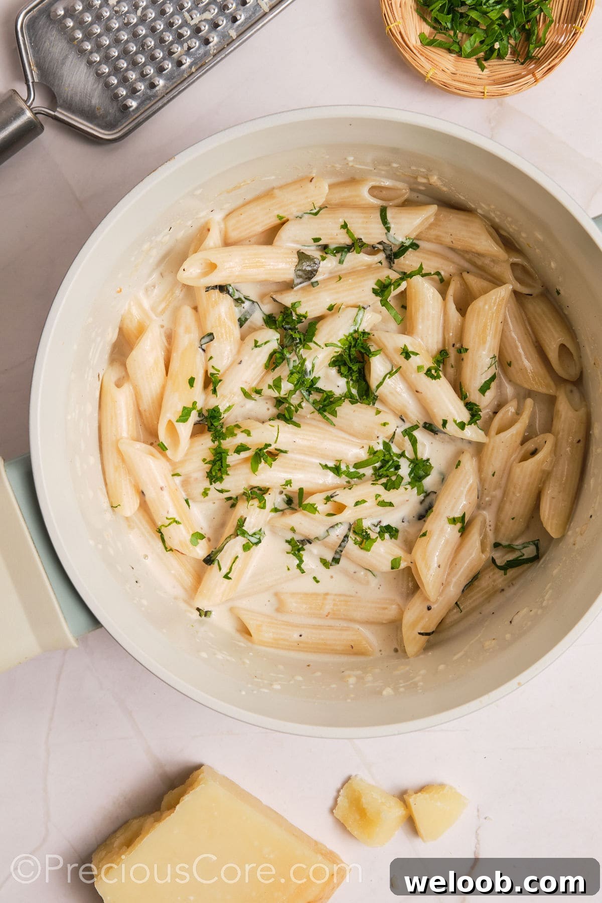 Basil and parsley added to creamy pasta.