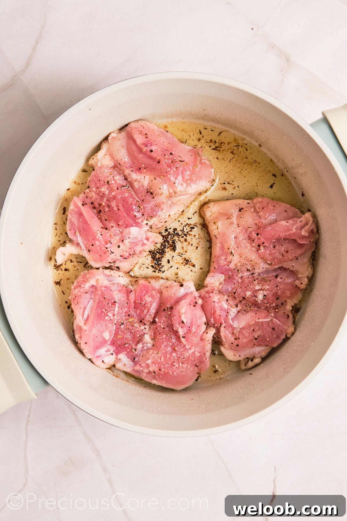Boneless chicken thighs cooking in a pot.