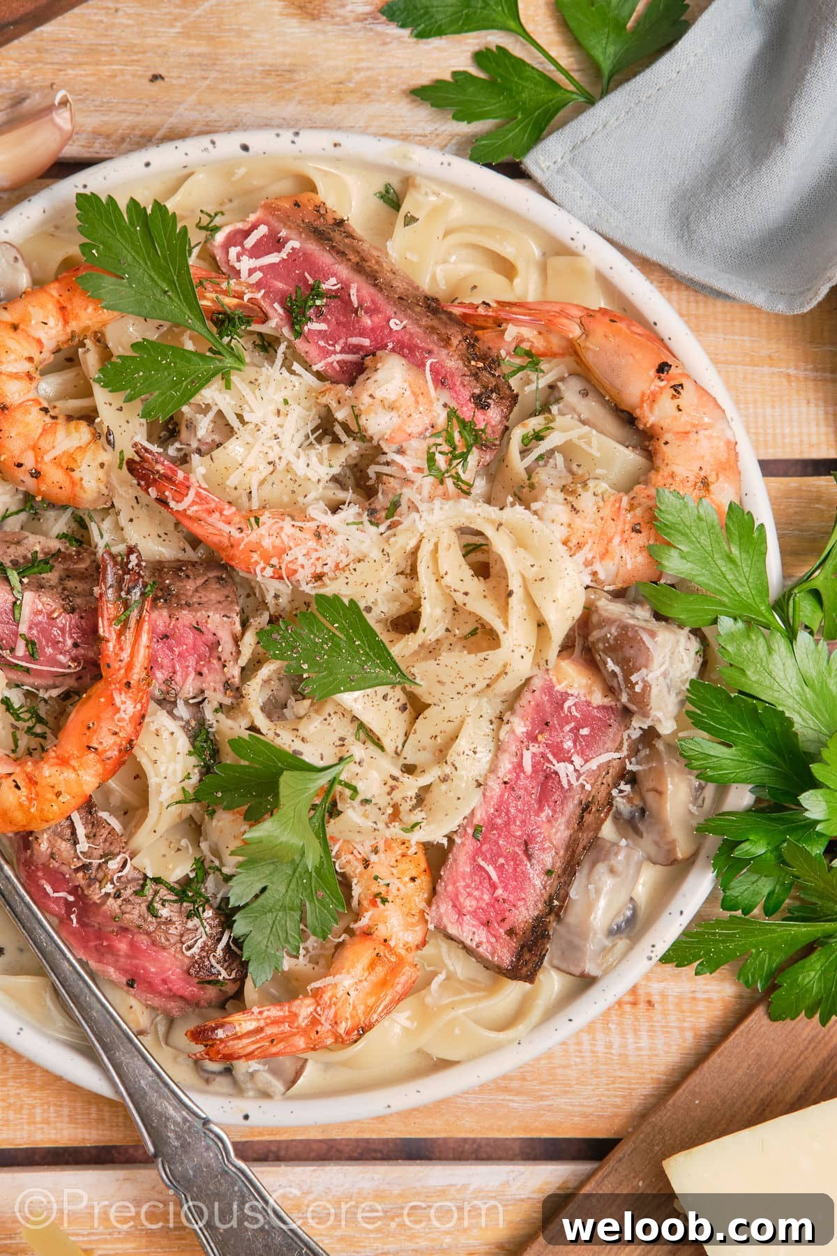 Creamy pasta topped with juicy steak and shrimp.