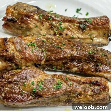 Square image of baked dry rub ribs.