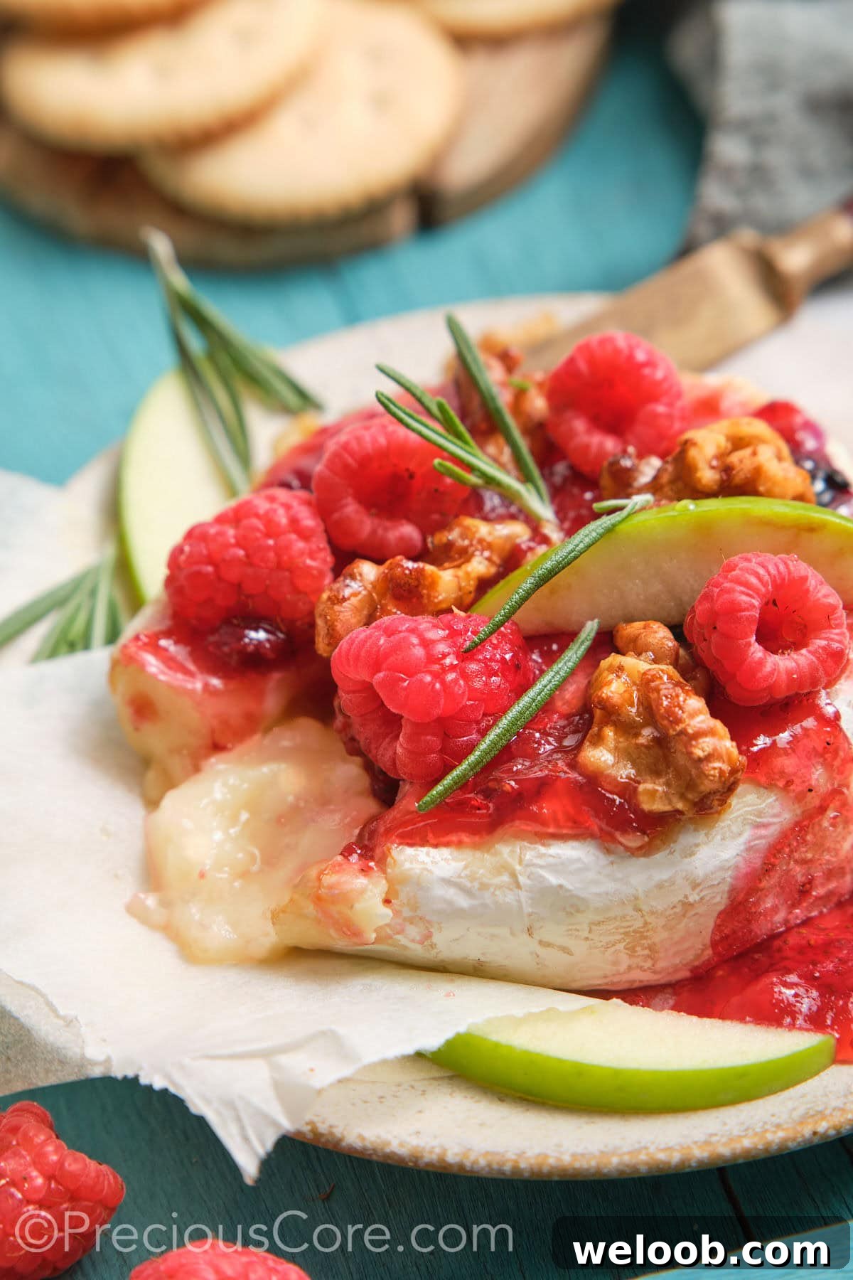 Served baked brie and preserves with melty cheese in the middle.