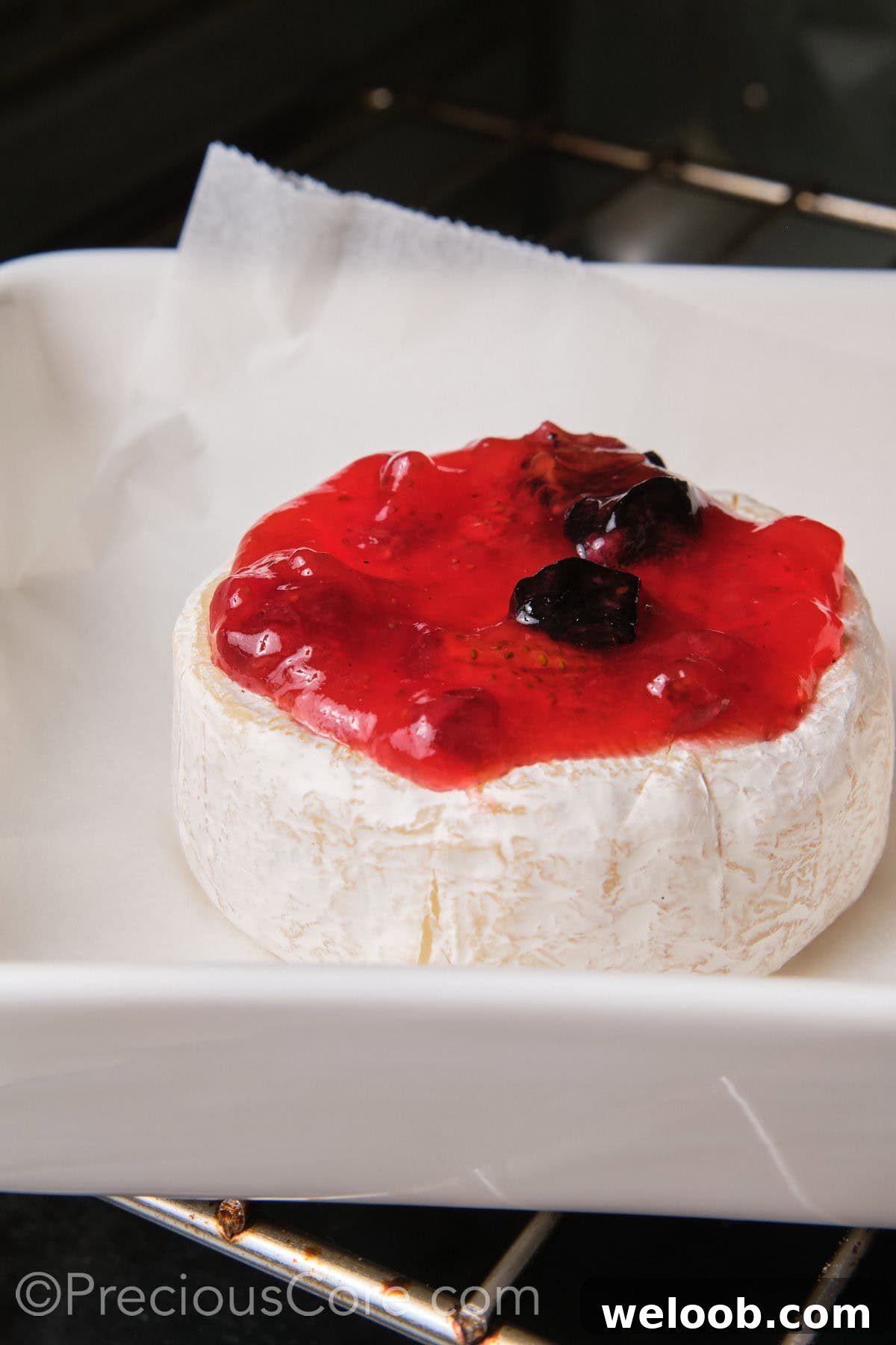 Baked Brie and fig preserves in the oven.
