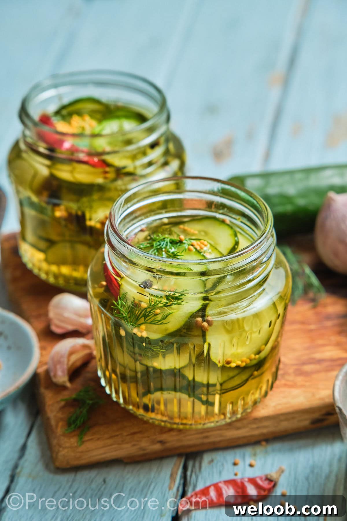 Two mason jars of homemade quick pickled cucumbers.