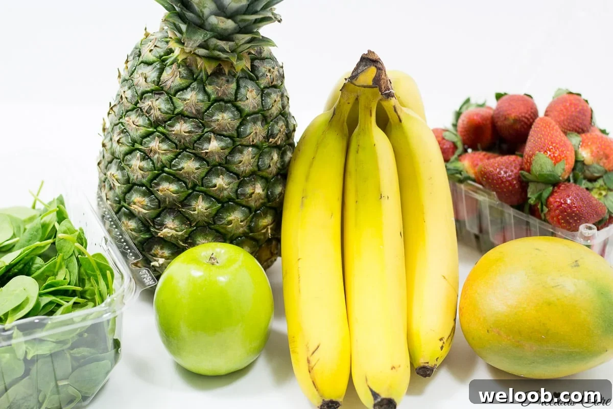 Fruits on a counter, including pineapple, banana, and strawberry.