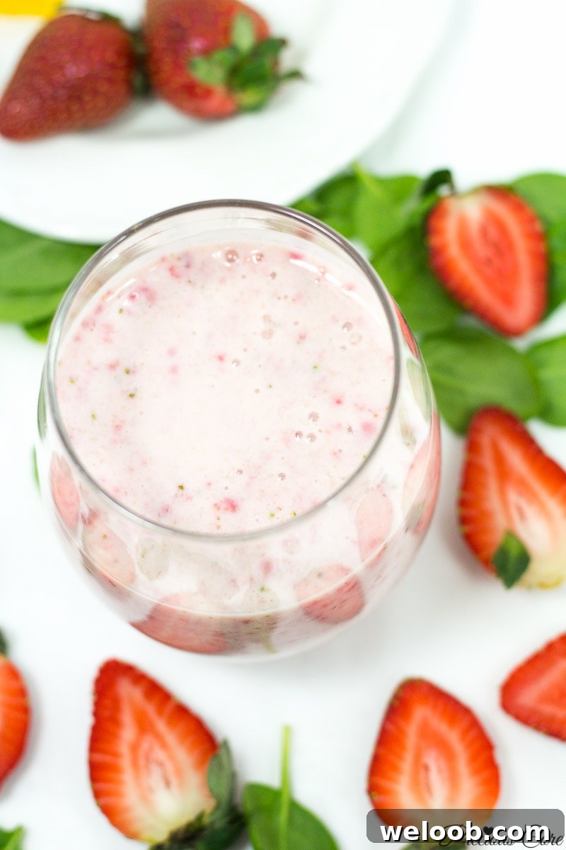 Strawberry banana smoothie in a small glass.