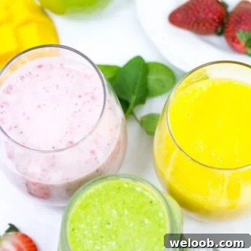 Three differently-colored smoothies in small glasses.