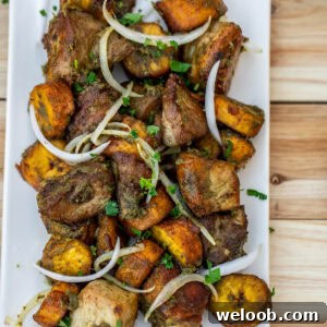 Fried pork an plantains topped with sliced onions.