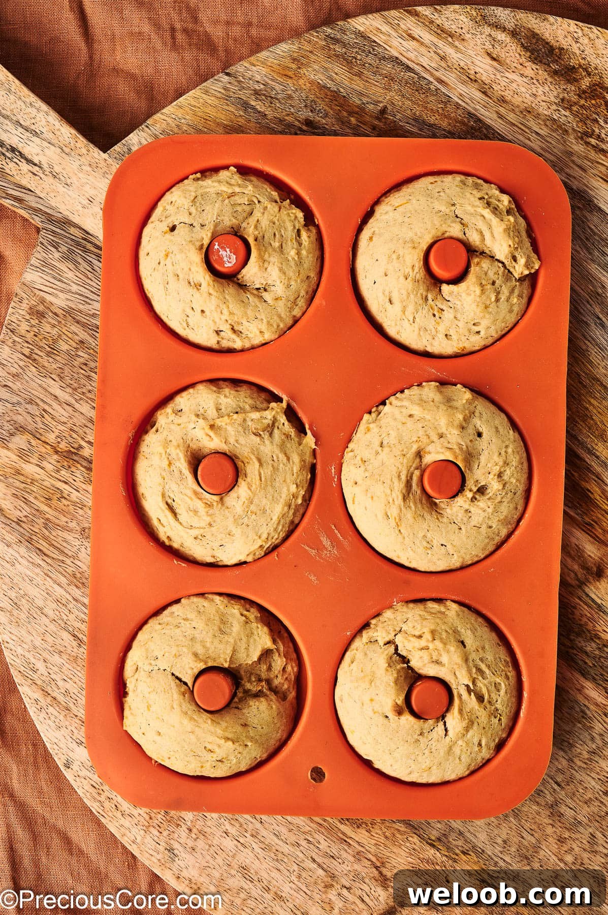 Baked pumpkin spice doughnuts in doughnut pan.