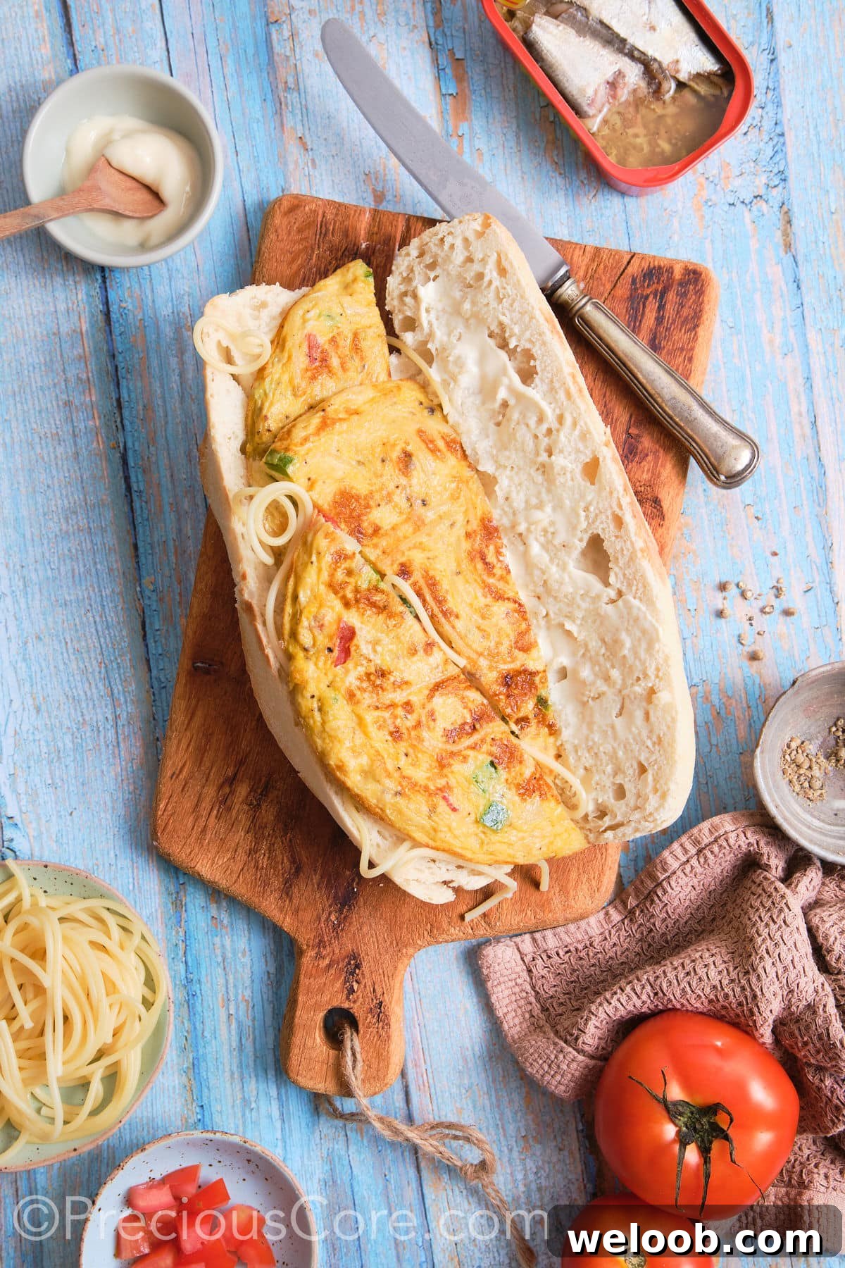 A French baguette open, one side laid with omelet.