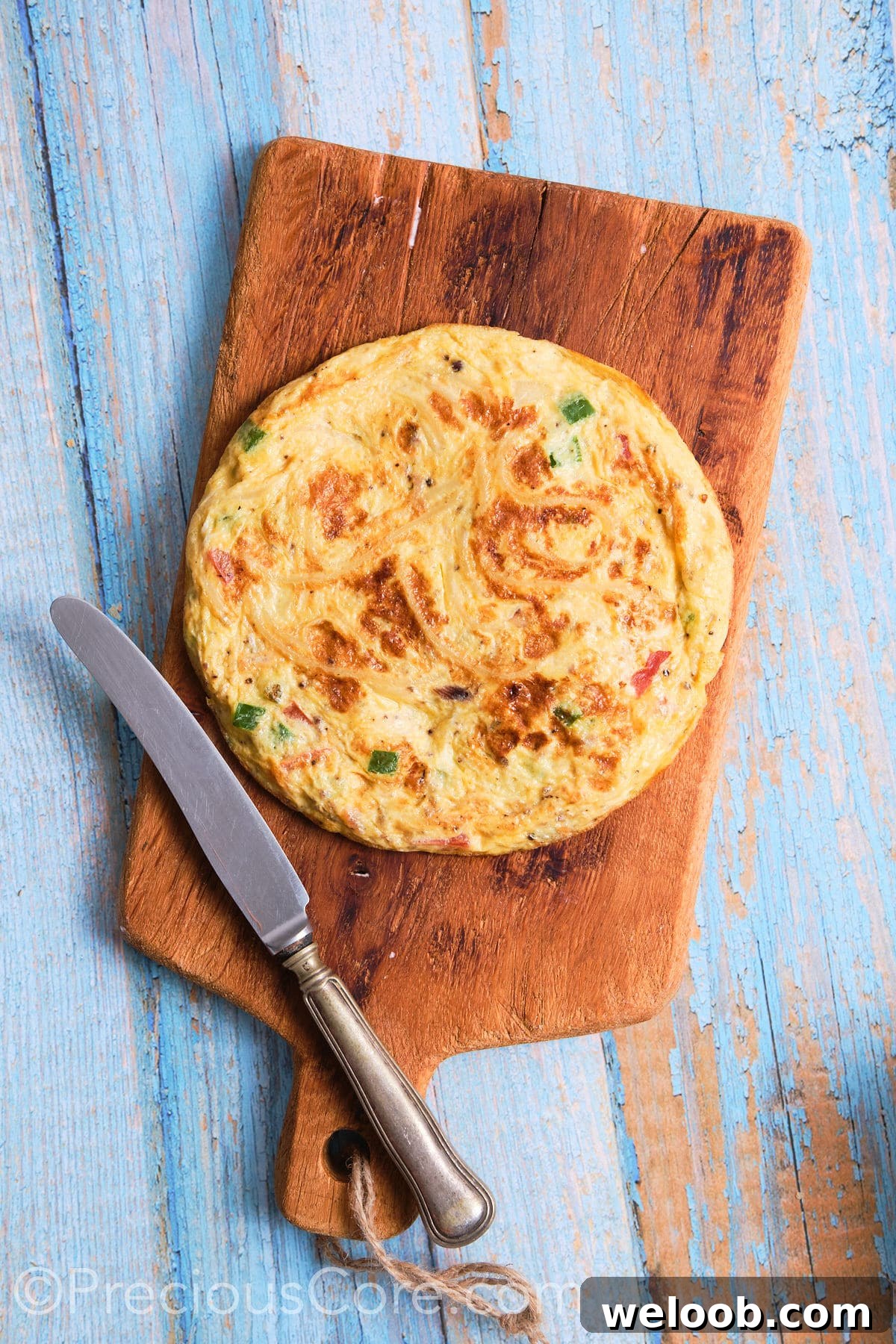 Spaghetti omelette placed on a cutting board.