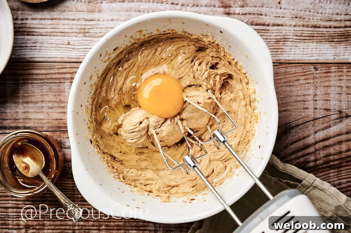 Adding eggs to butter mixture.