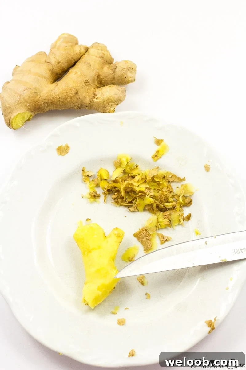 Peeled ginger on white plate.